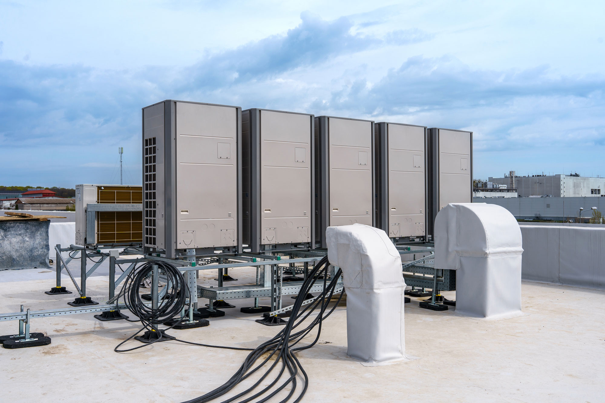 New rooftop units and conduit on a commercial roof